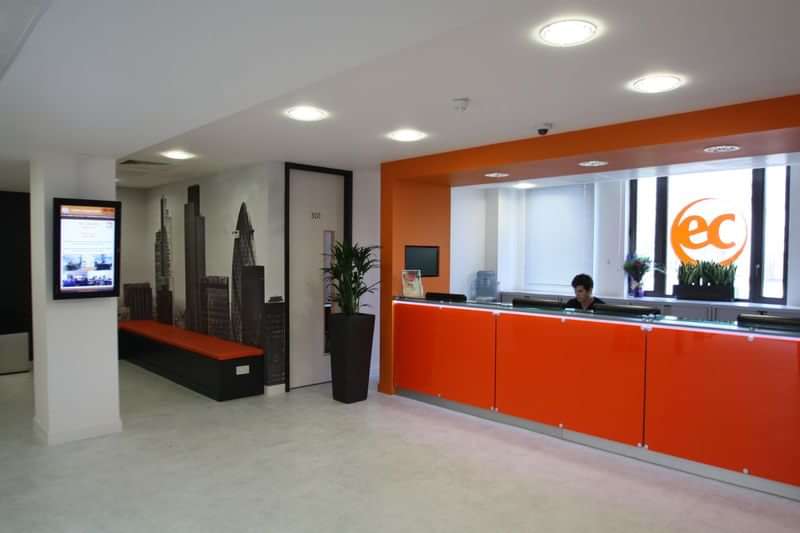 A language school reception area with modern design and welcoming atmosphere.