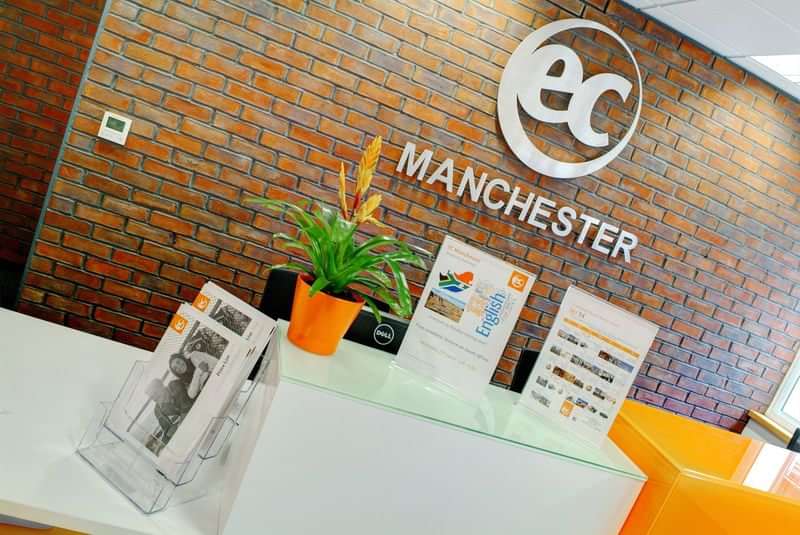 EC Manchester language school front desk with brochures and signage.