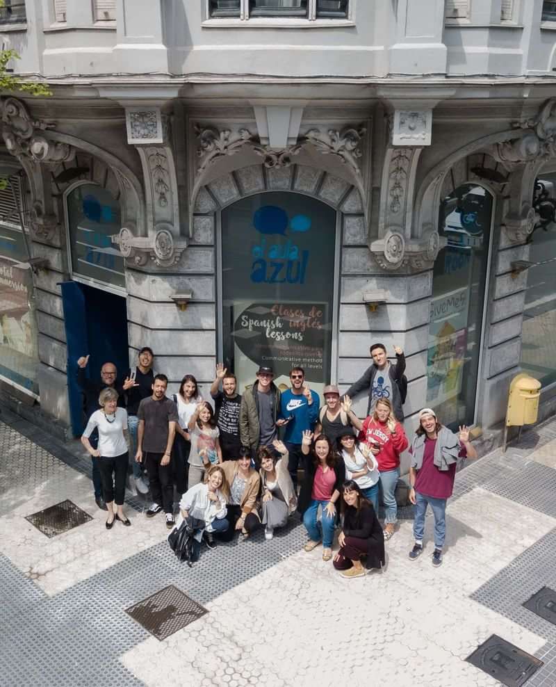 Groepsfoto van studenten voor een Spaanse taalschool in een stadsomgeving.