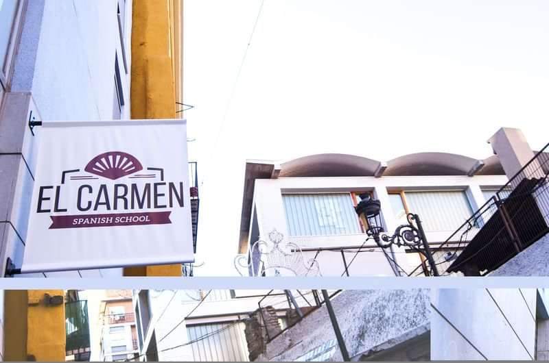 Sign for "El Carmen Spanish School" on a building facade.