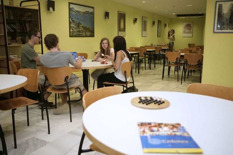 Studenten praten en studeren in een gemeenschappelijke ruimte in het buitenland.