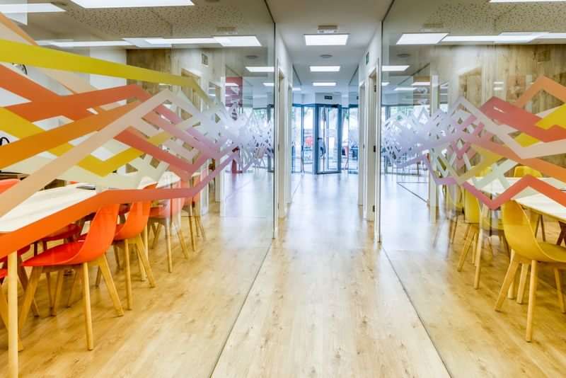 Language school common area with vibrant decor and seating.