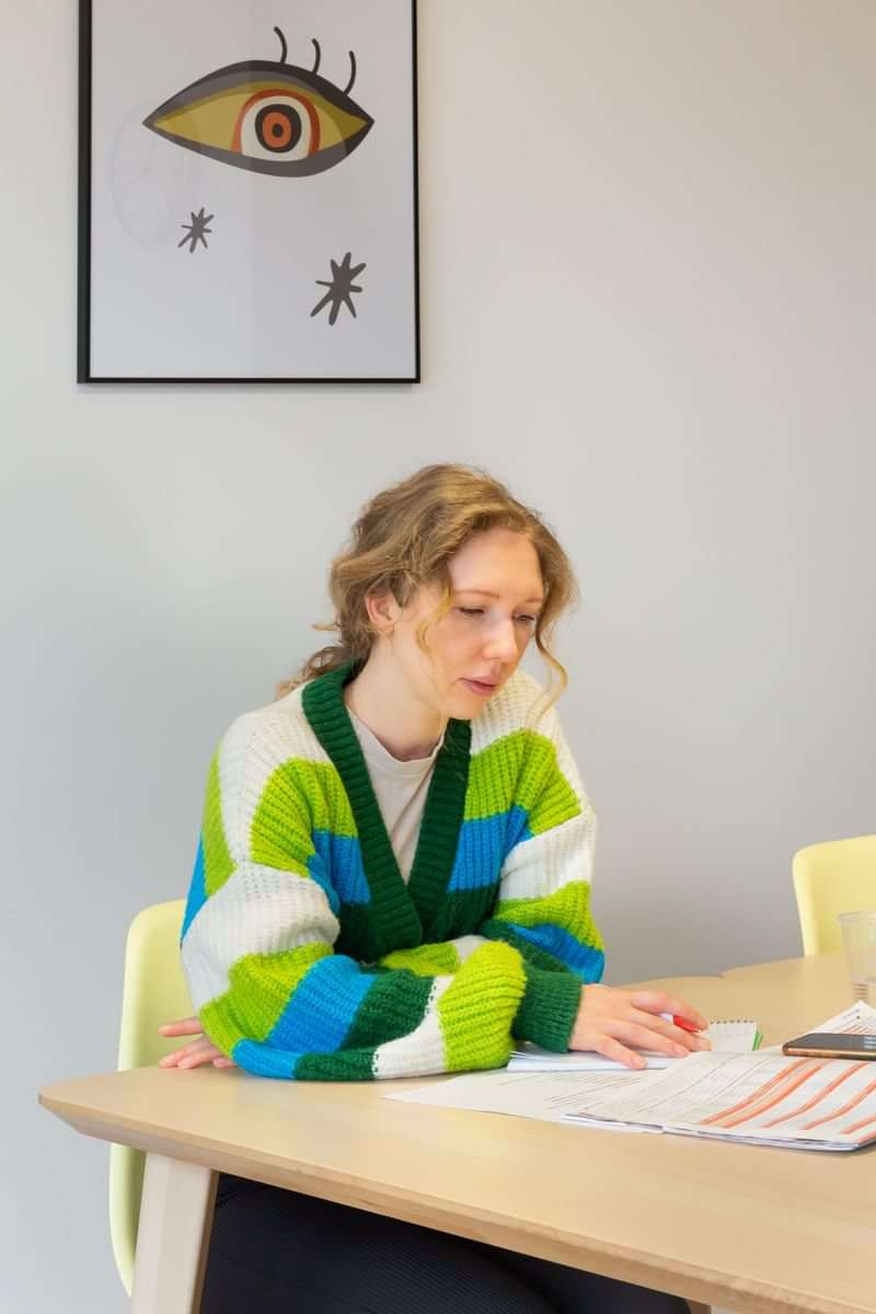 Woman reviewing documents, possibly preparing for language travel or study abroad.