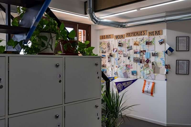 Student lockers, travel souvenirs board, indoor plants, and decor in language school.