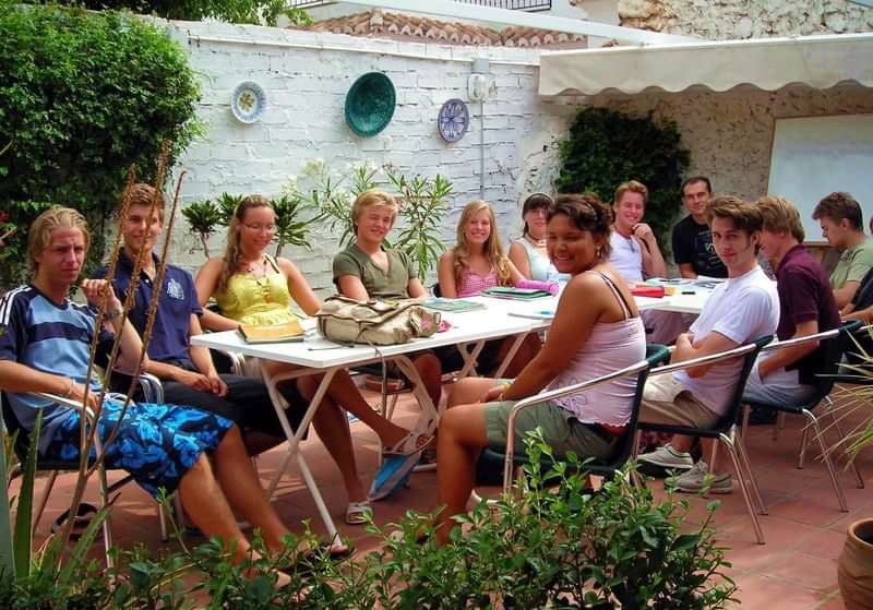 Students attending an outdoor language class, experiencing immersive learning abroad.