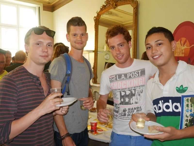 Group of young men socializing during a language exchange travel event.