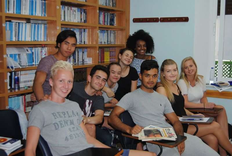 A group of international students in a language learning classroom.