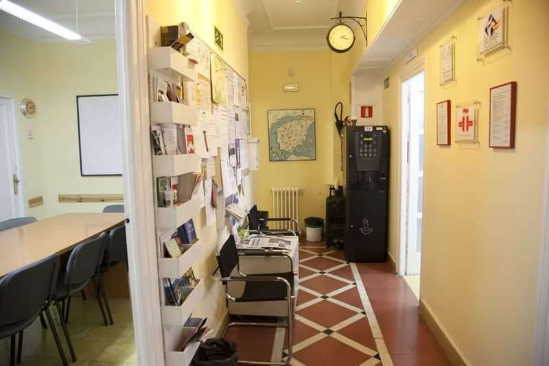 Language school lobby with maps, brochures, conference room, and vending machine.