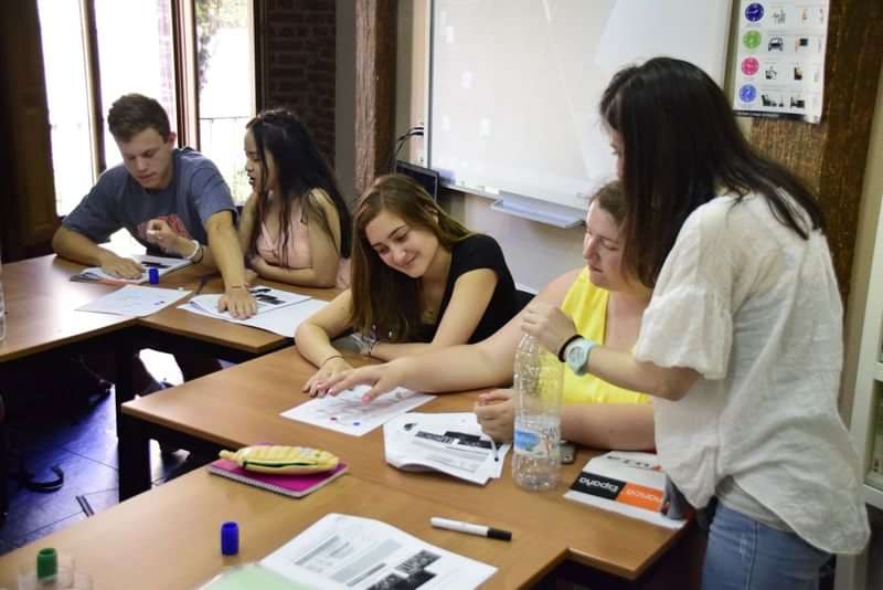 Students engaging in a language learning class with a teacher.