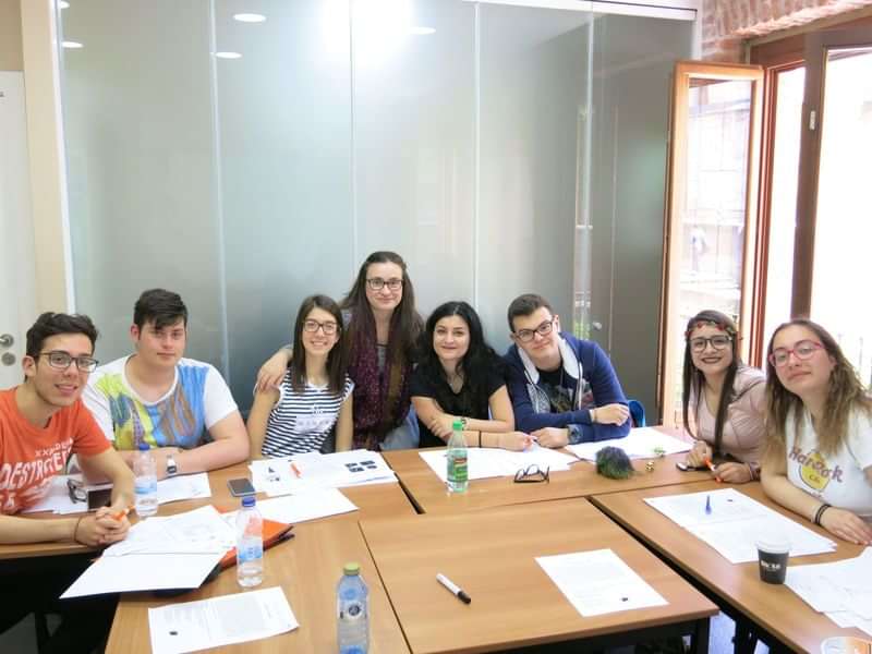 A group of students in a classroom learning a new language.