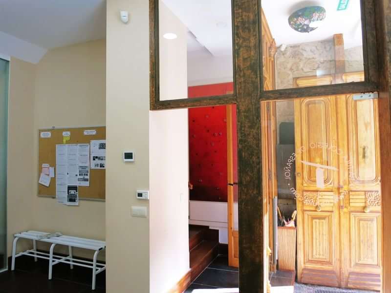 Language school common area with bulletin board and door to a classroom.