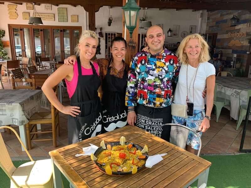 Group enjoying paella at a local restaurant.