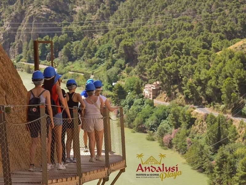 Group exploring Andalusi Playa's scenic views, wearing safety helmets, enriching cultural experience.