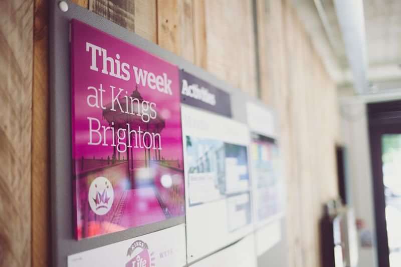 Noticeboard at Kings Brighton showing weekly events and activities for students.