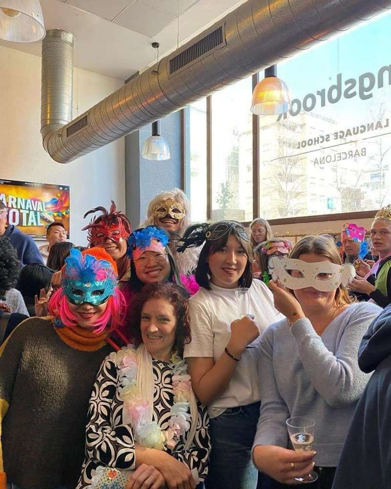 Group enjoying a festive and cultural event wearing colorful masks.