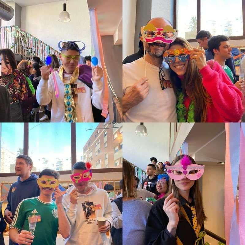 People enjoying a festive cultural event, wearing colorful masks and accessories.