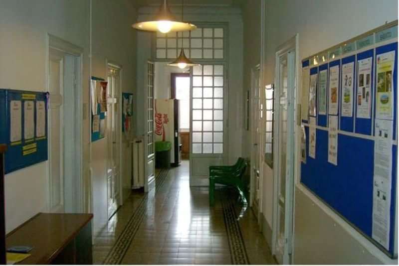 A language school hallway with bulletin boards displaying various information.
