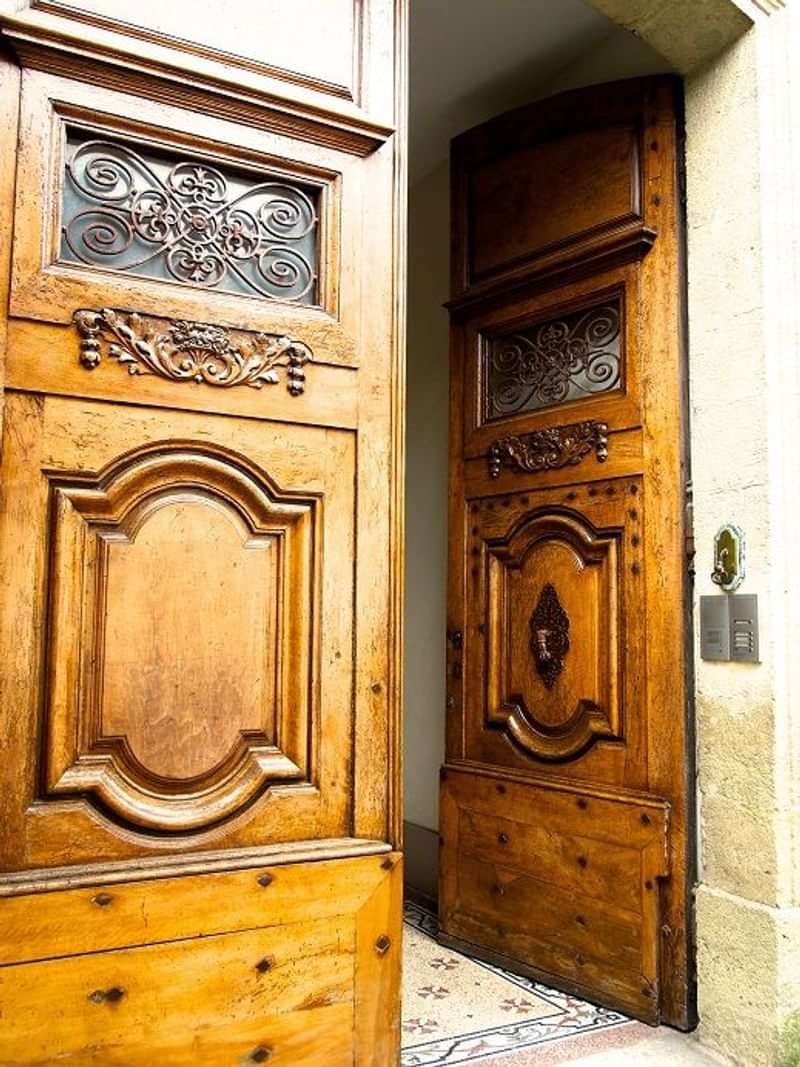 A charming wooden door welcoming guests, symbolizing cultural immersion and exploration.