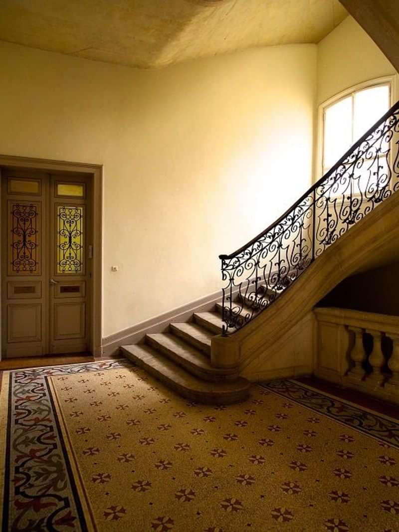 Historic building interior with ornate stairwell; cultural immersion spot.