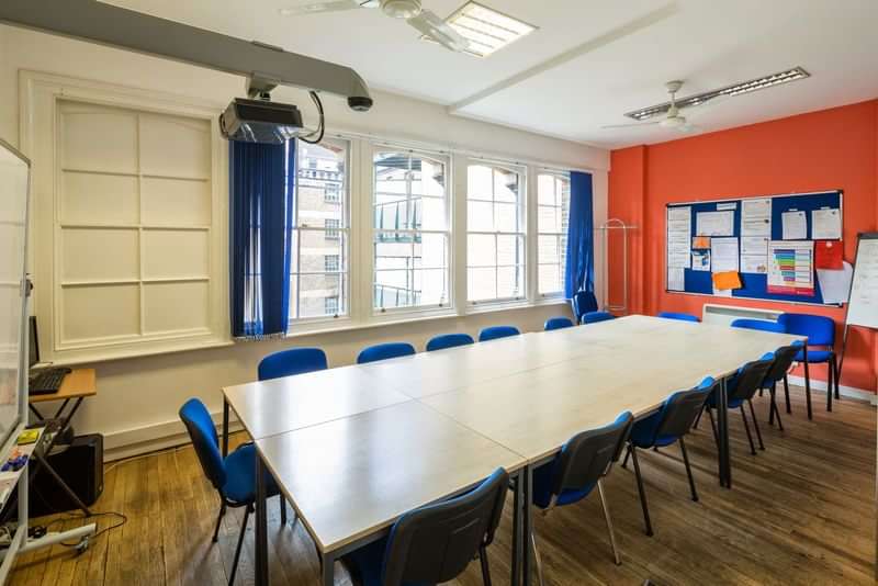 A well-lit classroom prepared for language learning sessions and meetings.