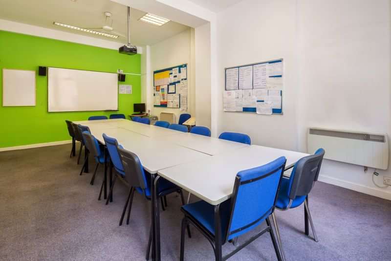 Classroom setup for language travel studies with whiteboards and seating.