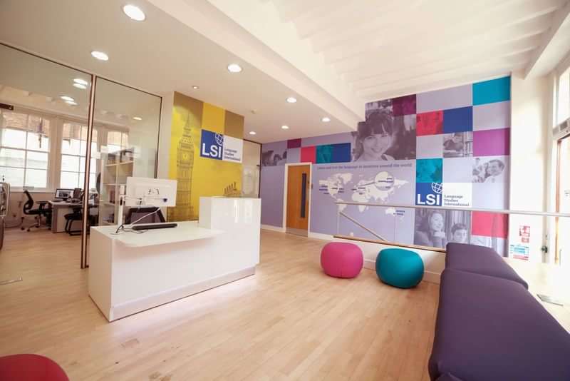 Language school reception area with colorful decor and modern seating.