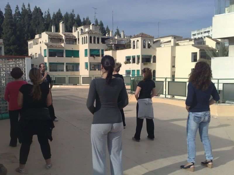 People practicing language skills in an outdoor urban setting.