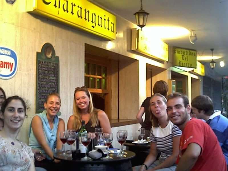 Friends enjoying drinks at an outdoor café in Spain.