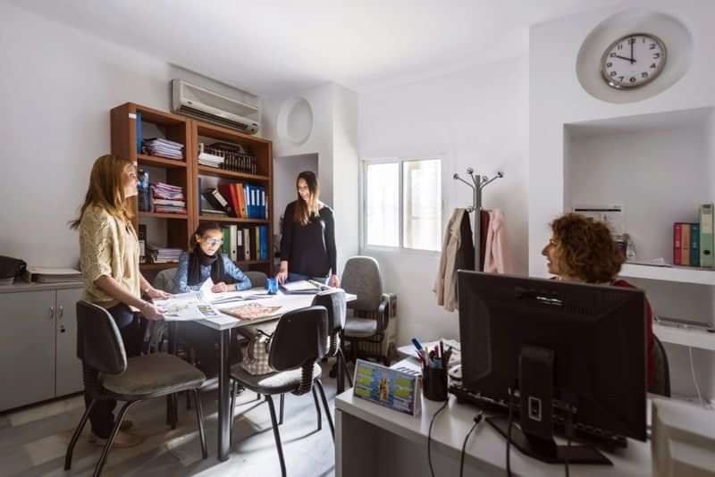 Language teachers and students in a classroom having a discussion.