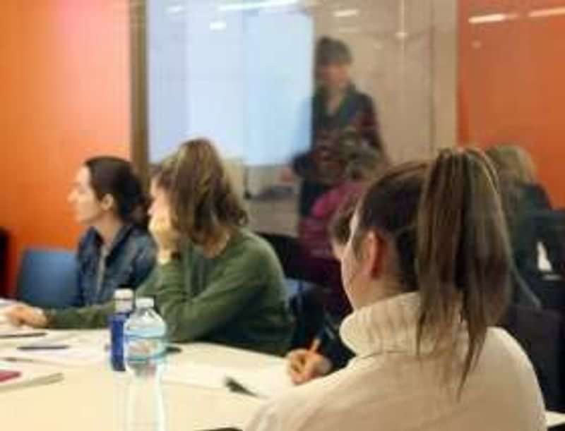 Students attending a language class, learning and taking notes attentively.