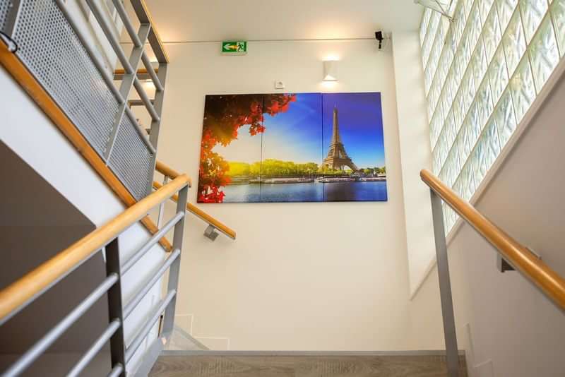 Staircase with Eiffel Tower picture, highlighting travel to Paris, France.