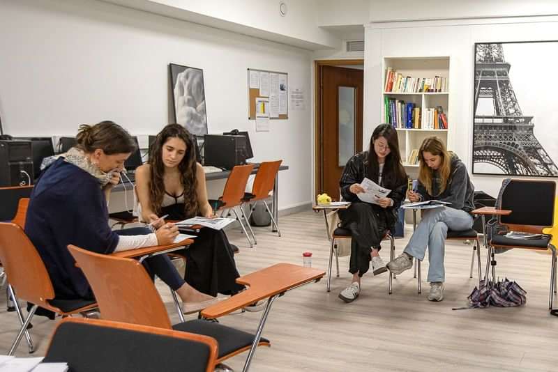 Students in a language class, learning and practicing together, in Paris.
