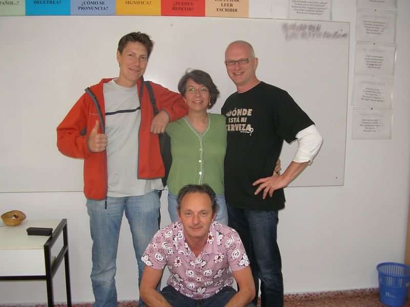 Group of four people in a language classroom setting.