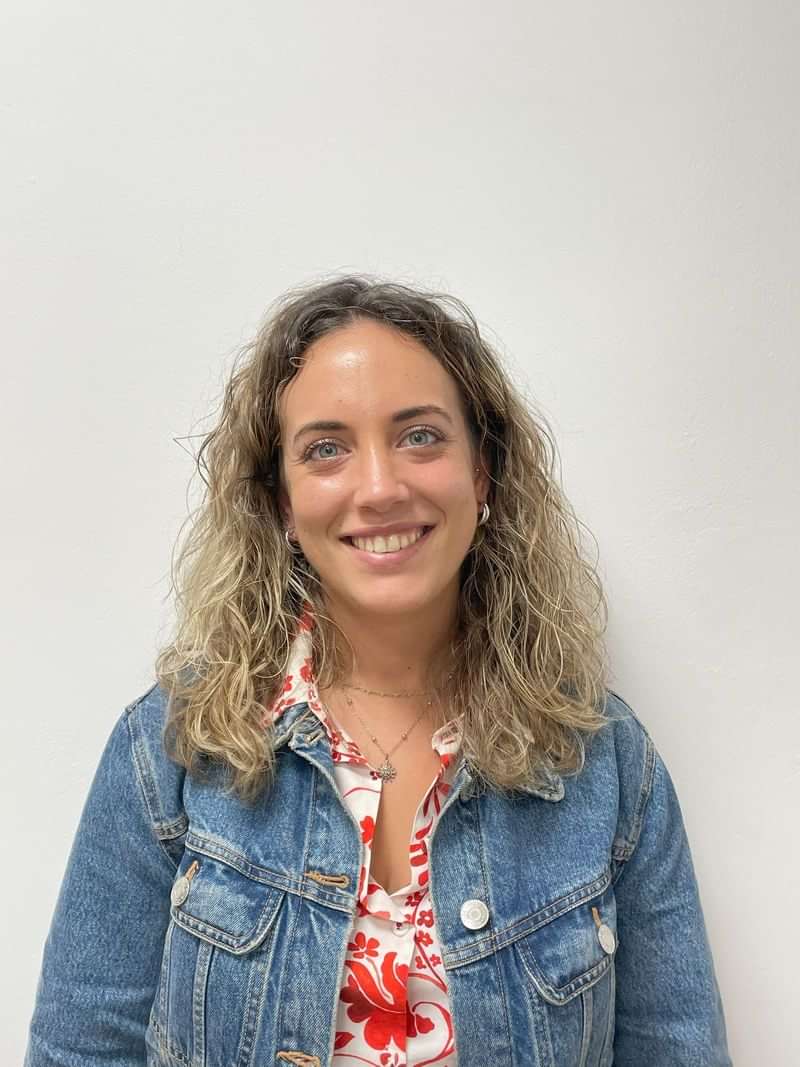 A smiling woman, potentially a language travel guide or educator.