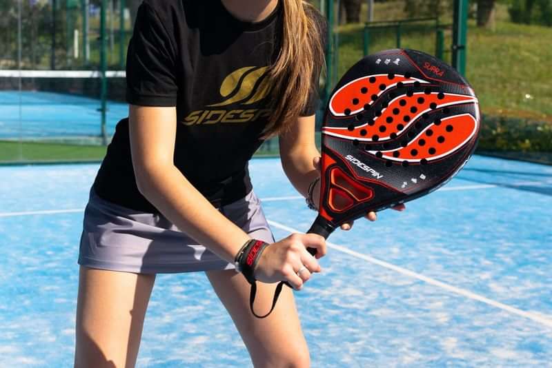 Playing paddle tennis, a popular sport in Spanish-speaking countries.