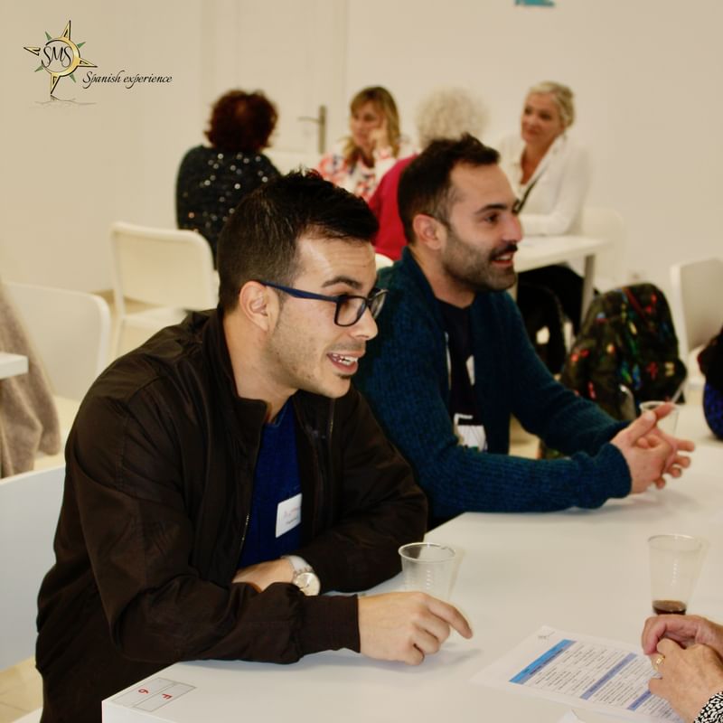 Participants engaging in a conversation exchange at a language travel event.