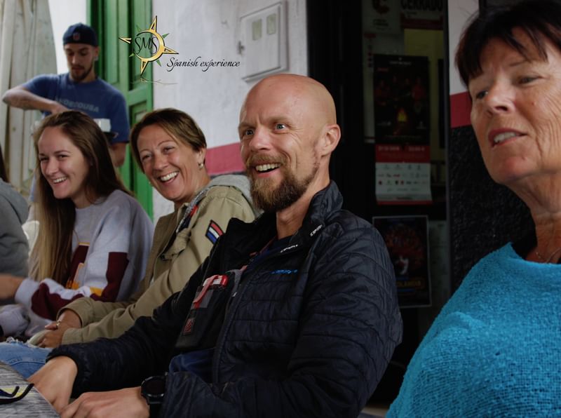 A group of people smiling during a language immersion experience.