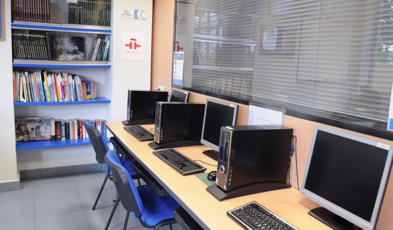 Taalreis: computers, boeken, studiemateriaal in een klaslokaal of bibliotheek.