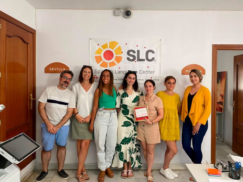 Group of people at Spanish Language Center with certificate.