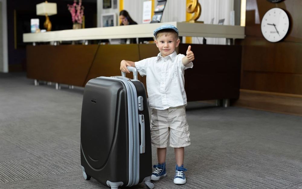 little-boy-with-a-big-suitcase-in-the-hotel.jpg