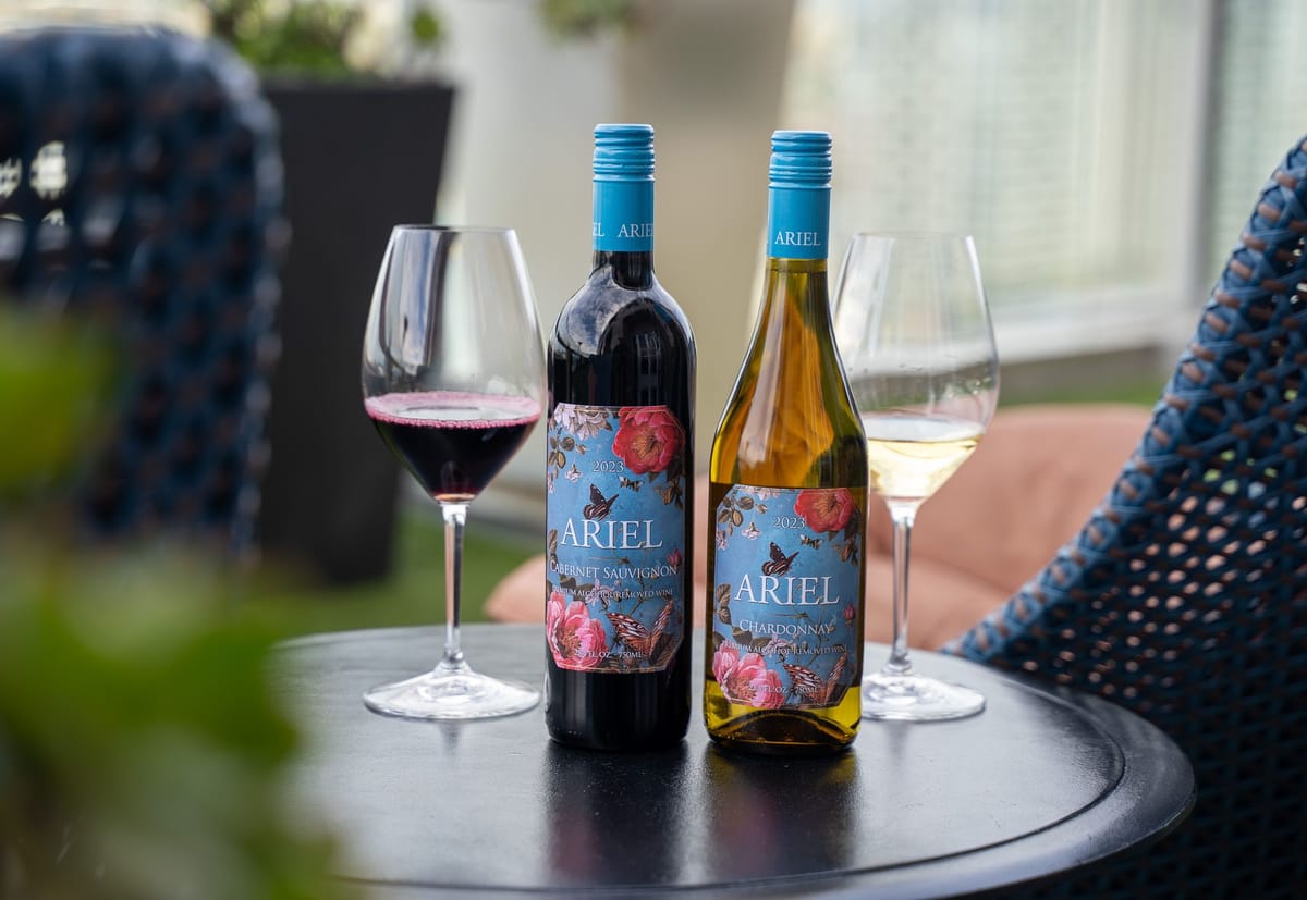 2 bottles of Ariel wine on a table next to wine glasses