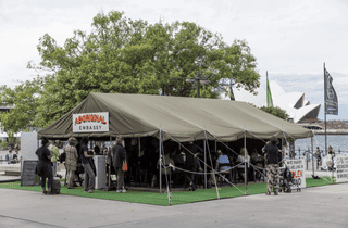 <span class="artist">Richard Bell</span><span class="title"> Embassy</span><span class="year"> 2013-ongoing</span>, <span class="medium">Canvas tent with annex, aluminium frame, rope, synthetic polymer paint on board, digital video, colour, sound; archive</span>, <span class="dimen dimen-notes">Dimensions variable</span>, <span class="notes">Installation view Biennale of Sydney, MCA Australia</span>