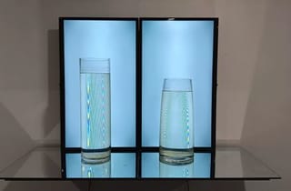<span class="artist">Ross Manning</span><span class="title"> Voids (Still Life)</span><span class="year"> 2024</span>, <span class="medium">LCD tvs, mirror, glass vases, distilled water, video file</span>
