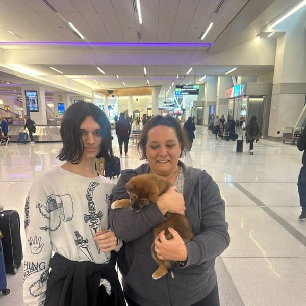Michele G. with Saigo, a Shiba Inu puppy