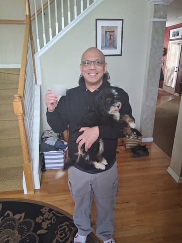 Pawrade customer Rizalino S. with their Bernedoodle, Mini puppy