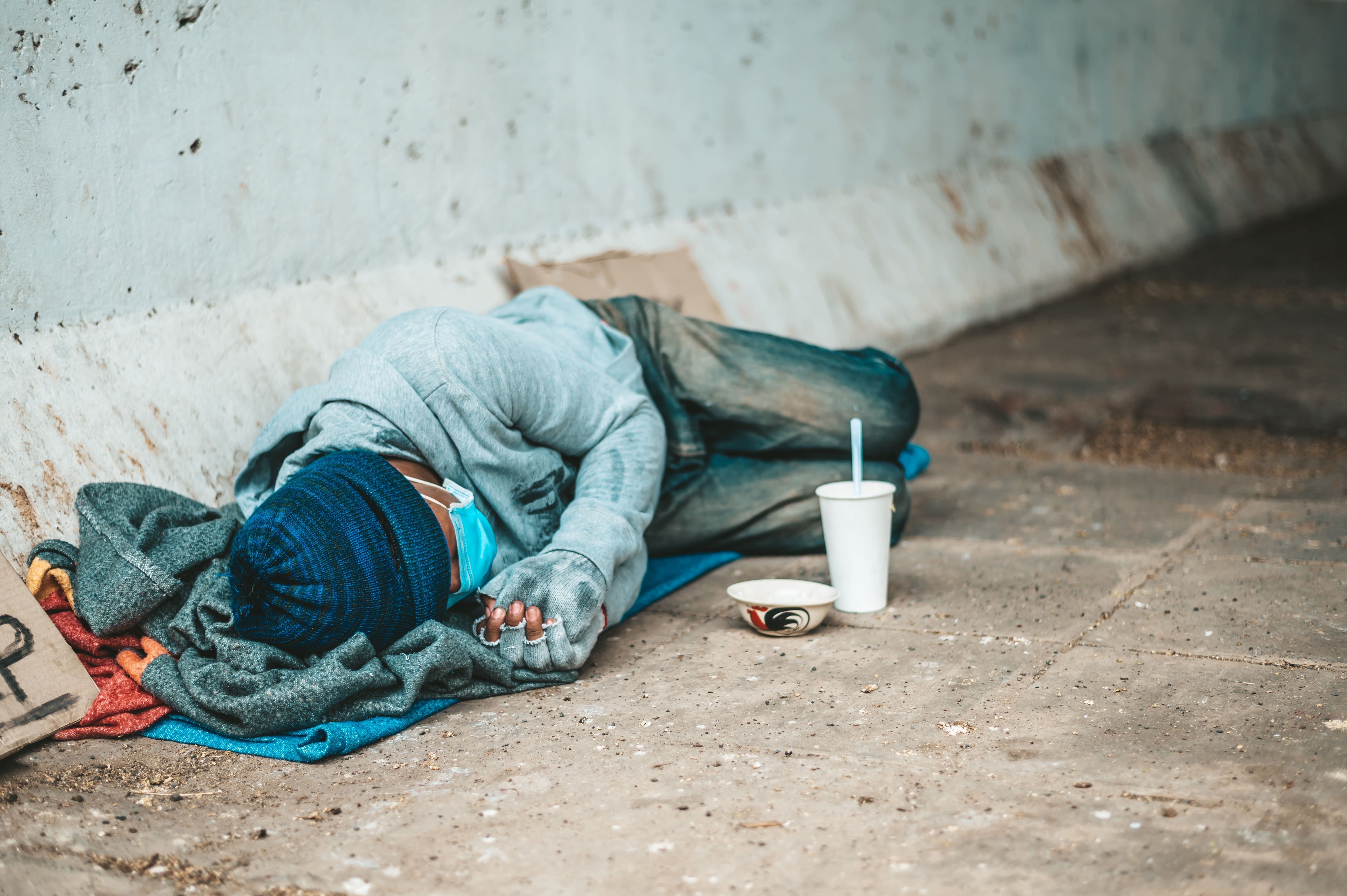 morador de rua dormindo no chão; citação sobre desigualdade para redação