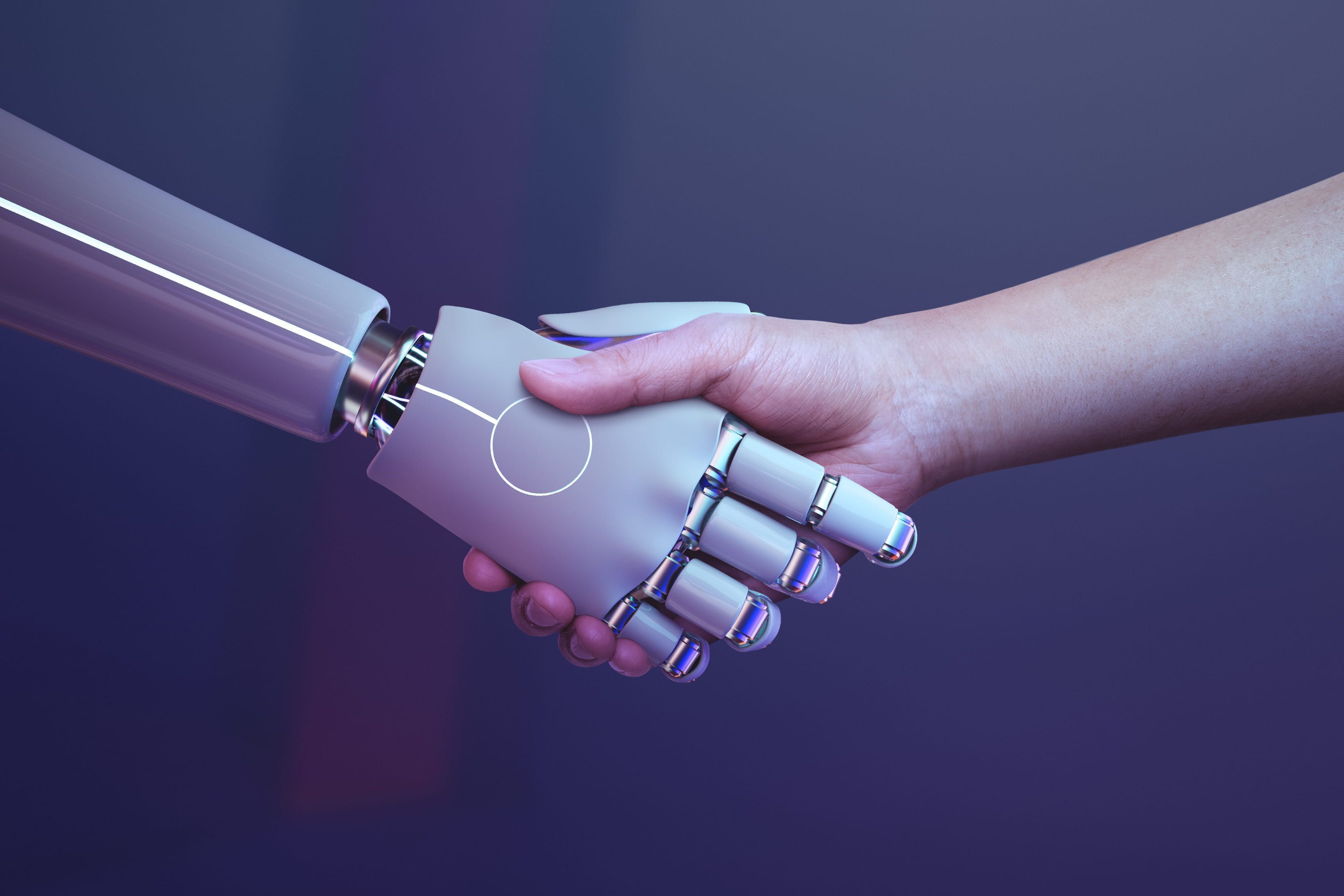 robô e humano dando as mãos