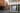 A glass fronted shop on the corner of a London street. There us a painting hanging in the shop window facing out to the street showing an abstract figure reclining.