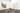 Two large monotone paintings hanging on a gallery wall with large hand carved wooden bowls placed on plinths on the floor in front of the paintings