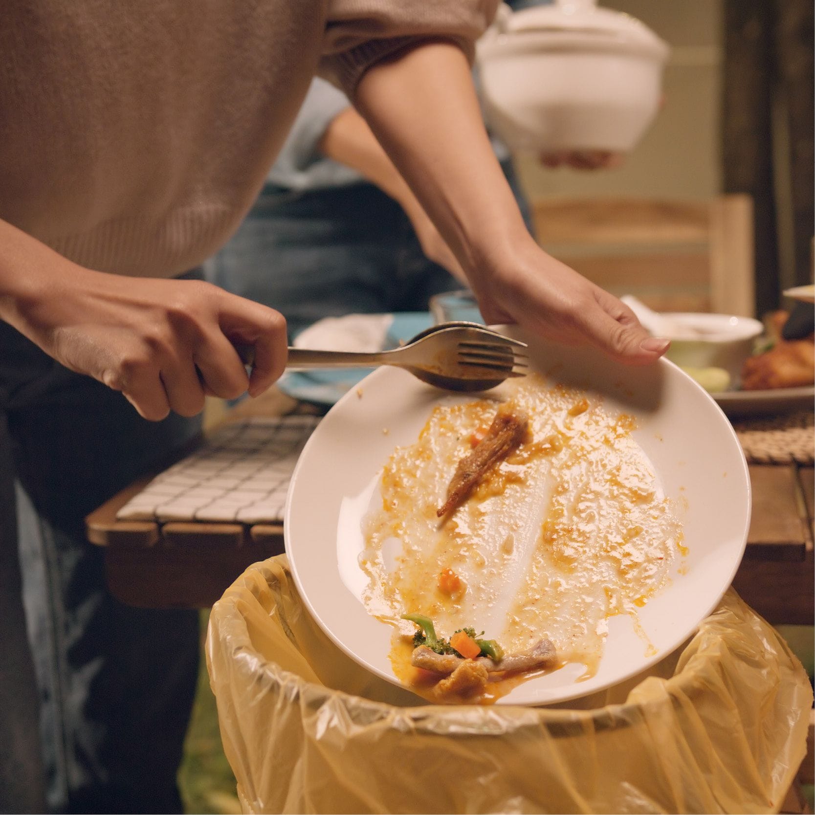 food scraps being put in a bin 